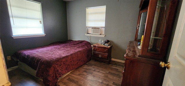 bedroom featuring cooling unit and dark wood-type flooring