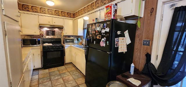 kitchen featuring ventilation hood, white cabinetry, and black appliances