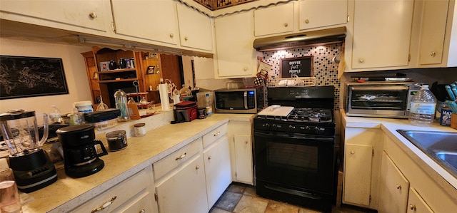 kitchen with white cabinetry, sink, and black gas range