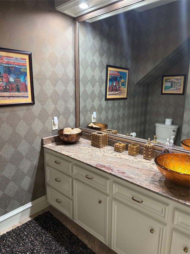 bathroom featuring vanity, toilet, and tile patterned floors