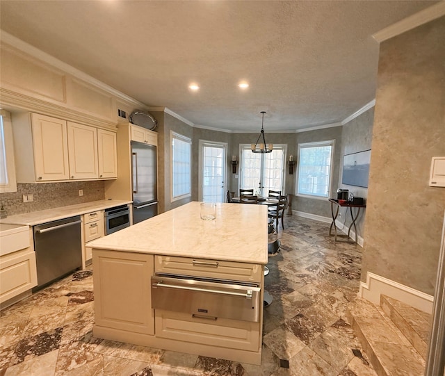 kitchen with light stone counters, pendant lighting, a kitchen island, appliances with stainless steel finishes, and crown molding