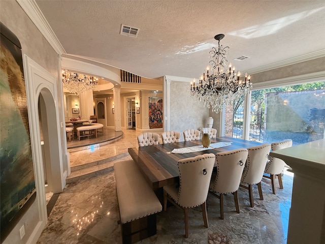 dining space with ornate columns, a chandelier, a textured ceiling, and crown molding