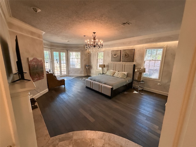 bedroom with a textured ceiling, crown molding, and dark hardwood / wood-style flooring