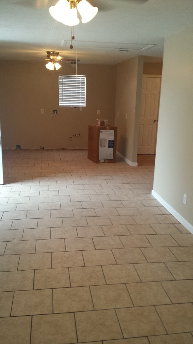 spare room featuring ceiling fan, heating unit, and light tile patterned floors