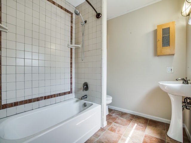 full bathroom featuring toilet, sink, and tiled shower / bath