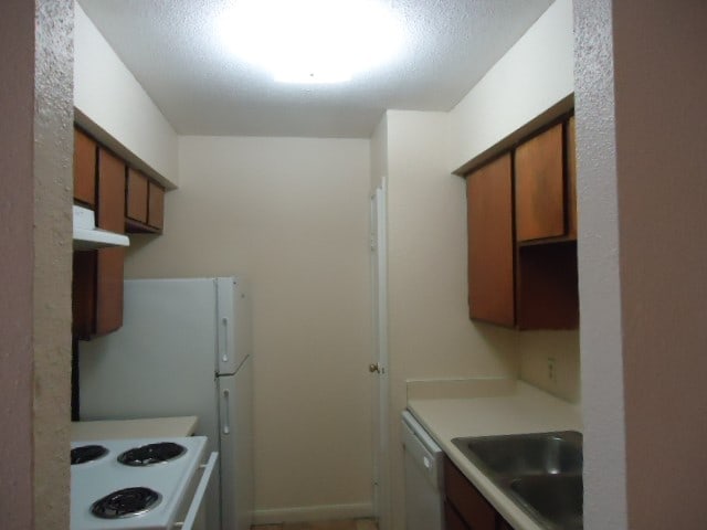 kitchen featuring sink and white appliances