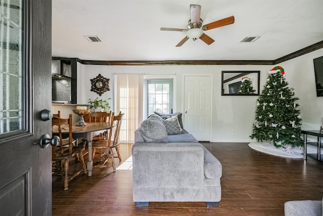 living room featuring ceiling fan, dark hardwood / wood-style floors, and ornamental molding