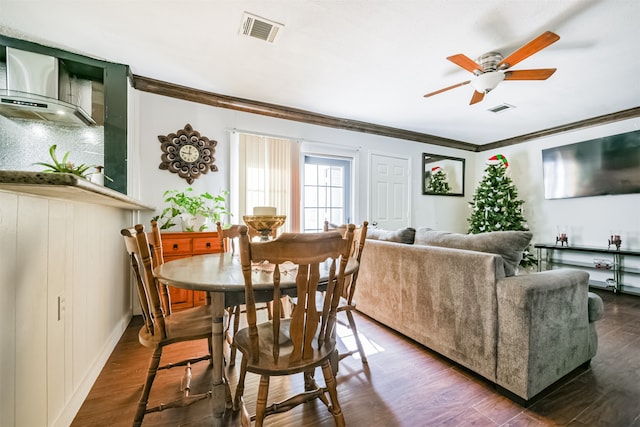 dining space with dark wood-type flooring, ceiling fan, and ornamental molding