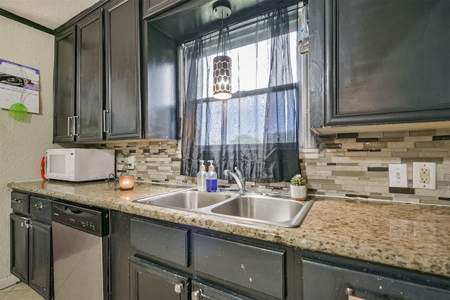 kitchen featuring dishwasher, tasteful backsplash, and sink