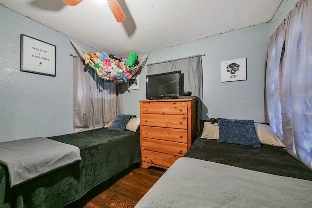 bedroom with ceiling fan and dark hardwood / wood-style floors