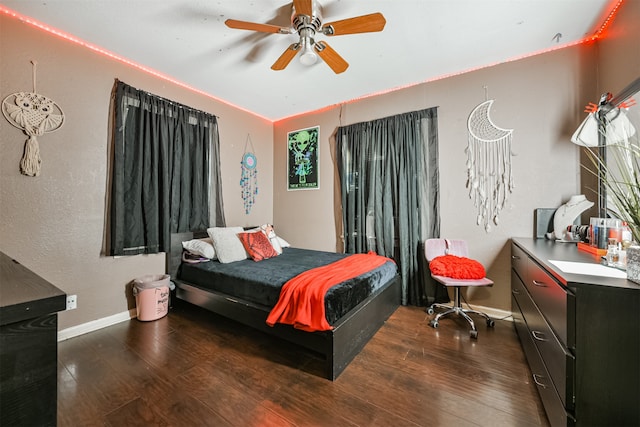 bedroom featuring dark hardwood / wood-style flooring and ceiling fan