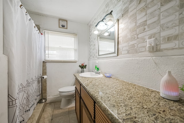 bathroom with vanity, tile patterned floors, and toilet