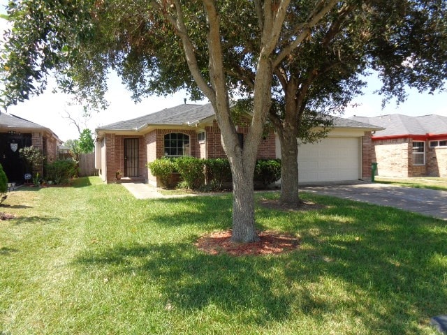 single story home featuring a front yard and a garage