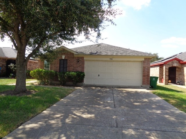 ranch-style house with a front yard and a garage