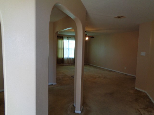 hallway with dark colored carpet