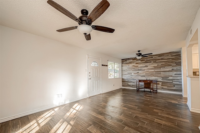 foyer entrance featuring ceiling fan, a textured ceiling, and dark hardwood / wood-style floors