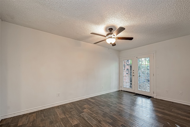 empty room featuring ceiling fan, a textured ceiling, french doors, and dark wood-type flooring