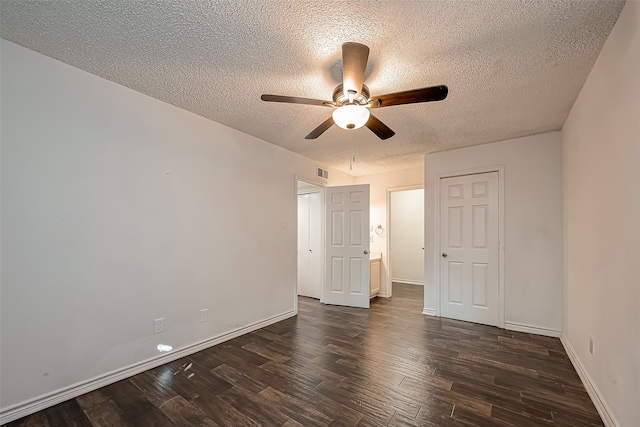 unfurnished bedroom featuring ceiling fan, a textured ceiling, and dark hardwood / wood-style floors