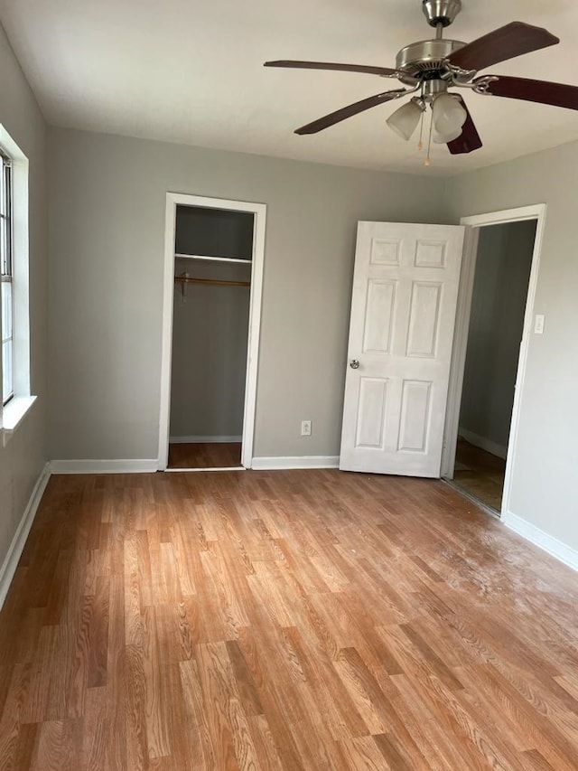 unfurnished bedroom with ceiling fan, a closet, and light hardwood / wood-style flooring