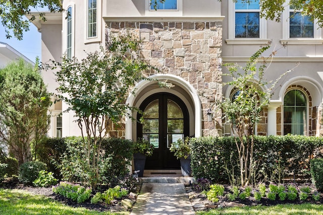 view of exterior entry featuring french doors