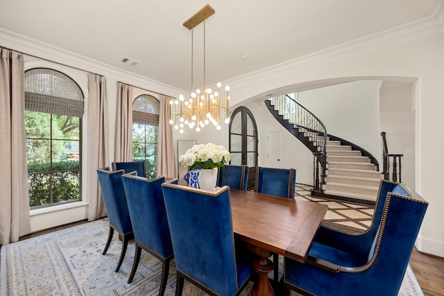 dining space featuring a notable chandelier, hardwood / wood-style floors, and crown molding