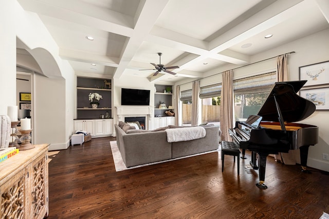 living room with coffered ceiling, beamed ceiling, built in features, ceiling fan, and dark hardwood / wood-style floors