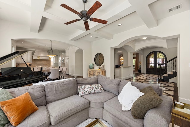 living room with coffered ceiling, beam ceiling, and ceiling fan