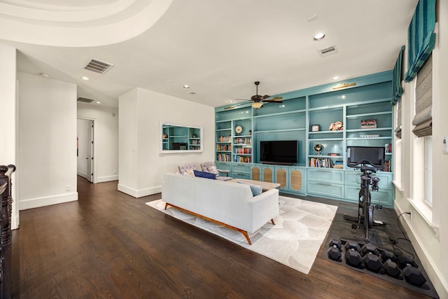 living room with ceiling fan, dark wood-type flooring, and built in features