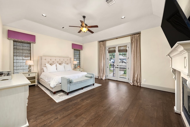 bedroom with access to outside, dark hardwood / wood-style flooring, ceiling fan, and french doors