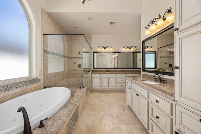 bathroom featuring vanity and separate shower and tub