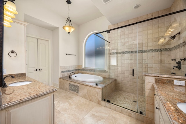 bathroom featuring independent shower and bath, vanity, and tile patterned floors