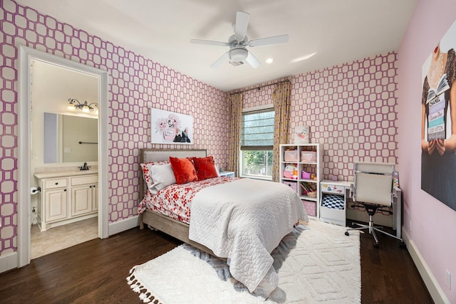 bedroom with ceiling fan, dark wood-type flooring, and ensuite bathroom