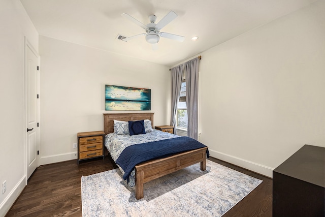 bedroom with ceiling fan and dark wood-type flooring