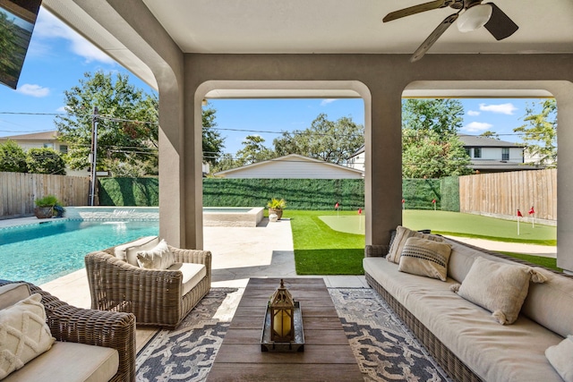 view of patio with an outdoor living space, ceiling fan, a fenced in pool, and pool water feature