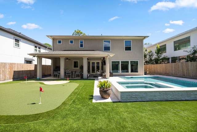 back of property featuring a pool with hot tub and a patio area