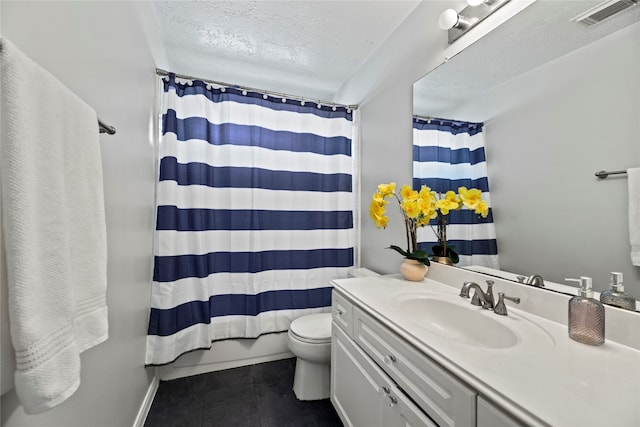 bathroom featuring vanity, toilet, a textured ceiling, and tile patterned floors