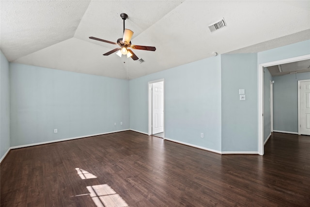 unfurnished room with a textured ceiling, vaulted ceiling, ceiling fan, and dark wood-type flooring