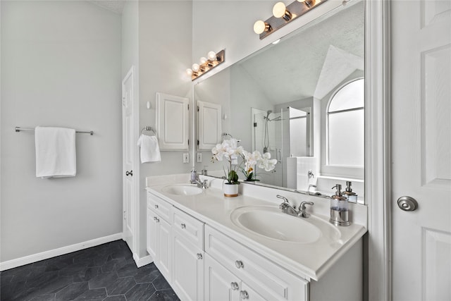 bathroom with a shower, vanity, a textured ceiling, lofted ceiling, and tile patterned flooring