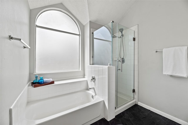 bathroom with shower with separate bathtub, vaulted ceiling, a textured ceiling, and a healthy amount of sunlight