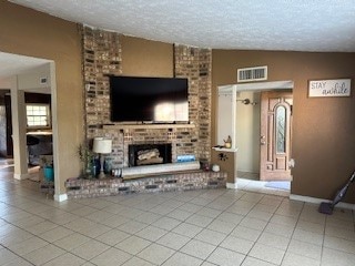 tiled living room featuring lofted ceiling, a textured ceiling, and a fireplace