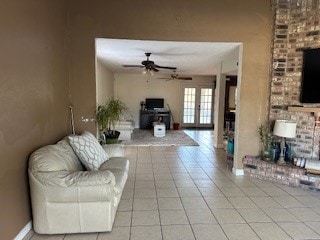 living room featuring light tile patterned flooring, french doors, and ceiling fan