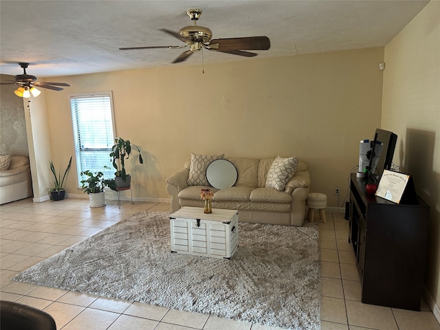 tiled living room with ceiling fan and a textured ceiling