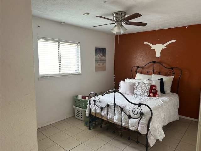 tiled bedroom with a textured ceiling and ceiling fan