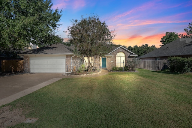 view of front of house with a yard and a garage