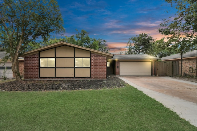 view of front of home with a yard and a garage