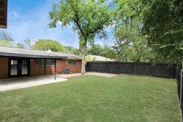 view of yard with a patio area and central air condition unit