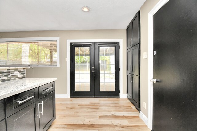 doorway with french doors and light wood-type flooring