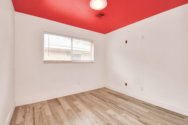 unfurnished room with light hardwood / wood-style flooring