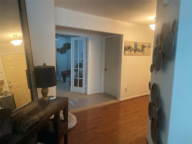 interior space with french doors and hardwood / wood-style floors