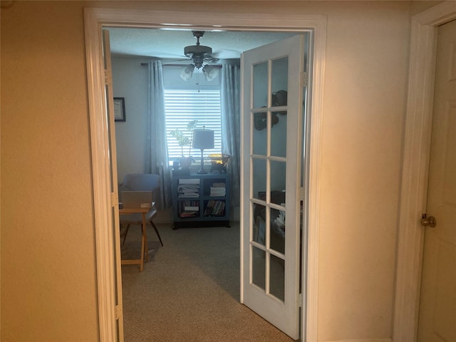 hall featuring carpet and french doors